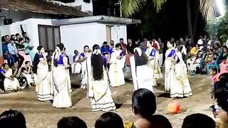 Kummiyattam danced by Kerala girls with a bunch of flowers in their sarees