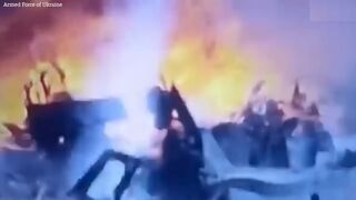 Ukrainian drone drops bomb into Russian tank hatch causing it to explode into pieces