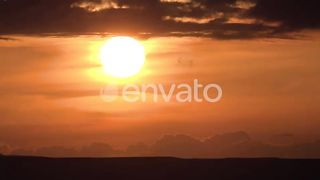 Sunset over horizontal dark cloud layers