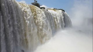 water falls from a mountain.