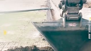 This digger operator uses extreme precision to dig out trenches for an irrigation system