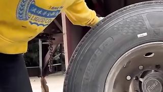 Powerful woman changing her truck tires