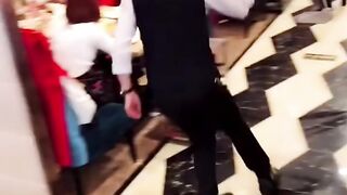 These waiters serve their clients while roller skating