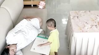 Toddler covers pregnant mother with blanket as she falls asleep