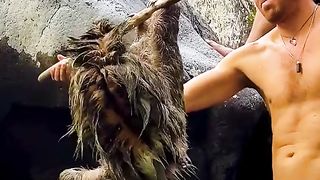 Passers-by rescue a sloth clinging to rocks after being washed down river.
