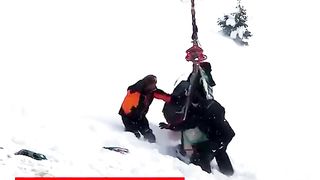 Helicopter rescue of a horse stuck on snowy mountain.