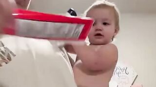 Baby holding every item handed to her