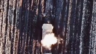 Russian tank explodes as Ukrainian drone drops bombs over hatch door