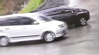 Driver show her skills to drive a stuck car in rain