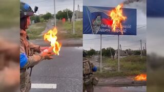 Ukrainian Soldier sets fire to Russian billboard with MOLOTOV COCKTAILS near Kharkiv