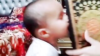 Cute baby with Quran pak