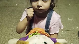 Cute baby telling about her doll