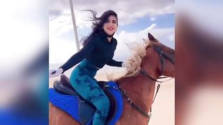 ENJOYING HORSE RIDING.