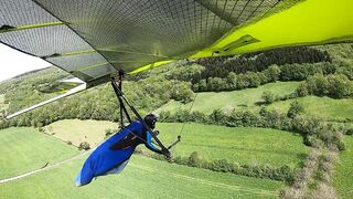 "Suspended Grace: The Serene Touchdown of a Paraglider"
