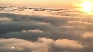 Flying behind the sun in the clouds