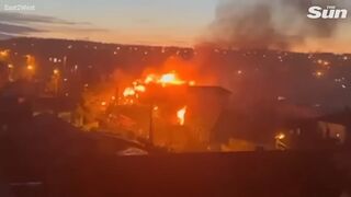 Fire rages on as Russian SU-30 plane explodes into building setting it ablaze