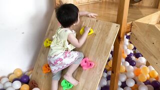 Baby cute at indoor playground with toys and balls