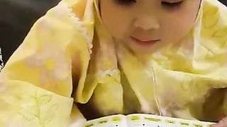 Little girl learning to recite