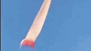 women fly .The Wind takes a Kite up and away with a woman