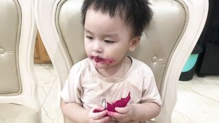 baby cute eating fruit in the house