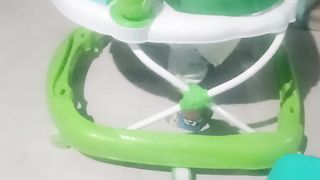 a small child playing on a small train is very cute