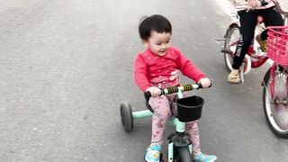 baby and sister outdoor bike ride