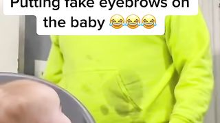 Putting fake eyebrows on the baby????????????