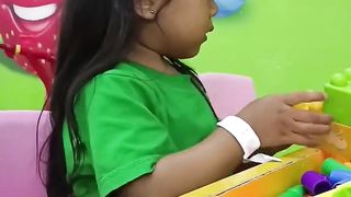 yumna and a ale are playing lego in the children's toy area