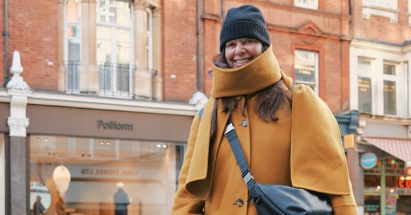 Julianne Idlet in mustardy winter coat walks Bernese Mountain dogs in London — Static01.nyt.com