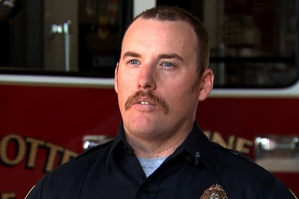 Firefighters Rescue Driver Standing on Submerged Truck in Pond — people.com