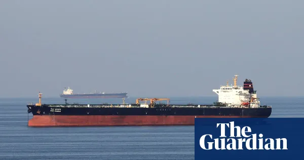 Three merchant ships struck as tensions rise in Hormuz strait amid Iran war — World news | The Guardian